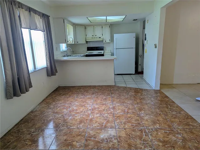 a kitchen with stainless steel appliances a refrigerator and a stove