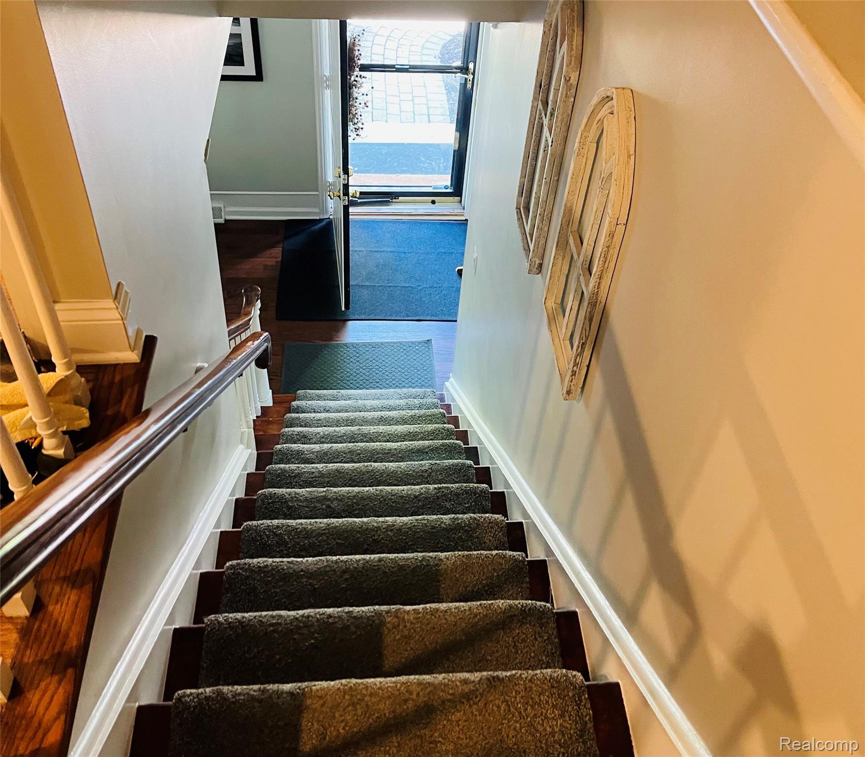488 Welch Road Northville, MI 48167 - Photo 9 of 22 Staircase with carpeted treads and wood-finish risers, complemented by a polished metal handrail