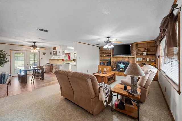 a living room with fireplace furniture and a window