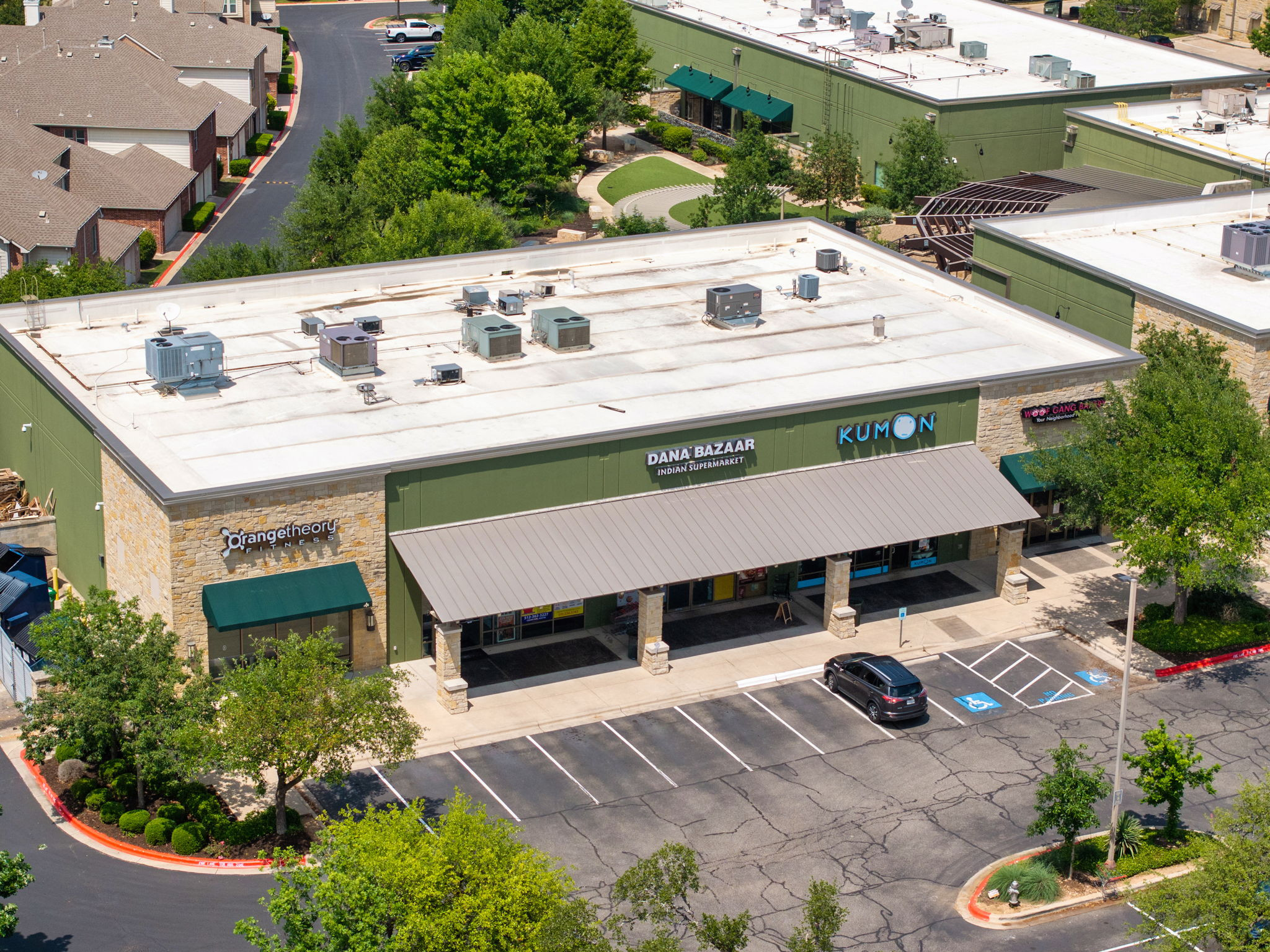 14815 Avery Ranch Boulevard, Unit 1401 Austin, TX 78717 - Photo 38 of 38 Commercial building featuring a stone and siding exterior with multiple storefronts