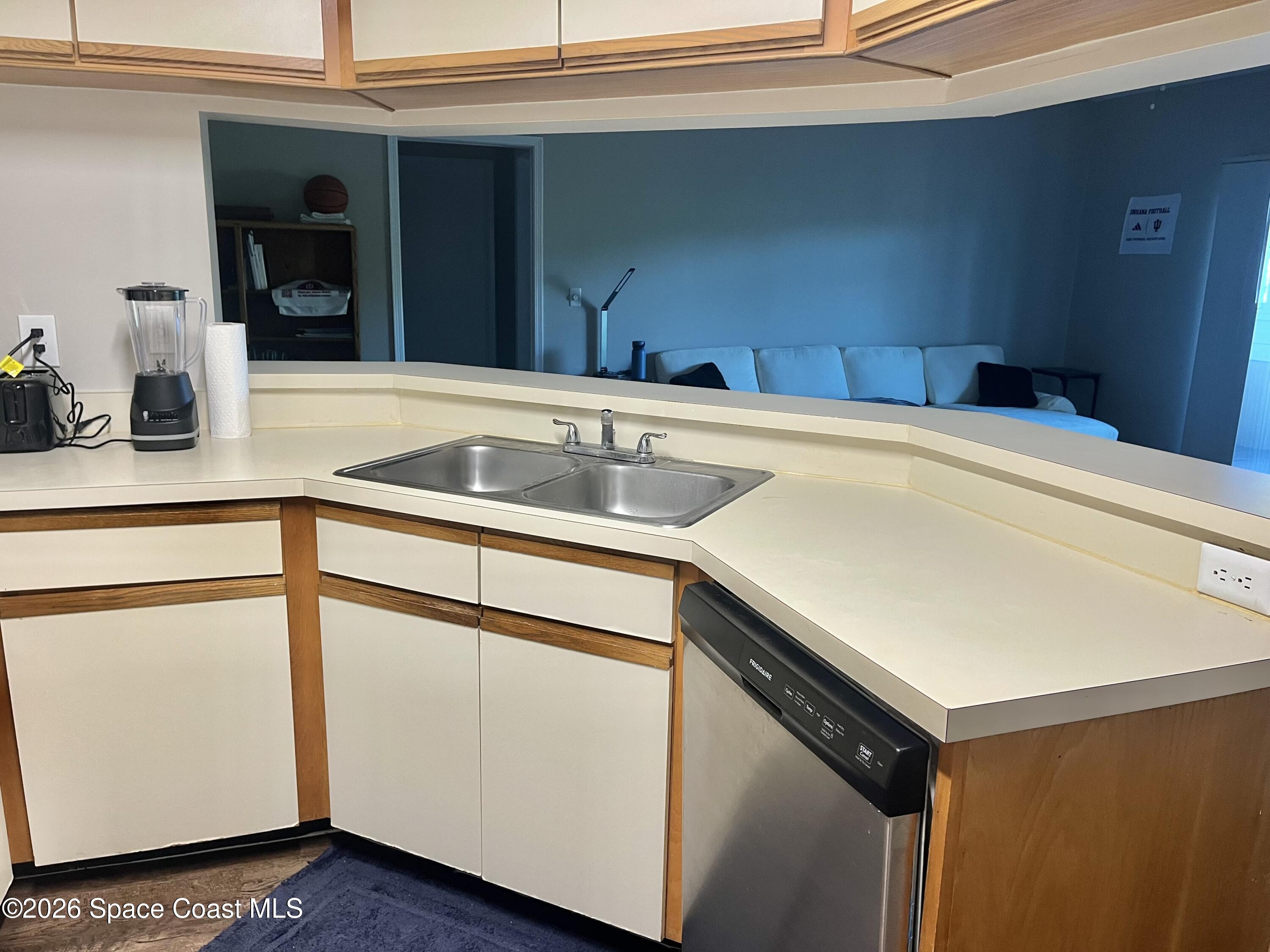 7667 North Wickham Road, Unit 1118 Melbourne, FL 32940 - Photo 3 of 26 a kitchen with a sink and cabinets