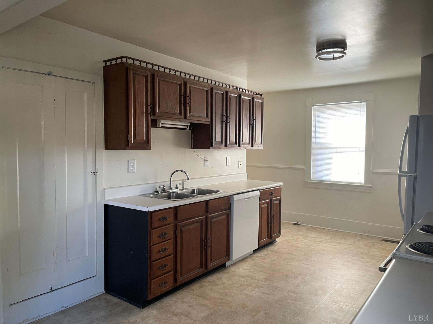 606 Jeter Street Bedford, VA 24523 - Photo 2 of 15 a kitchen with a sink cabinets and a window