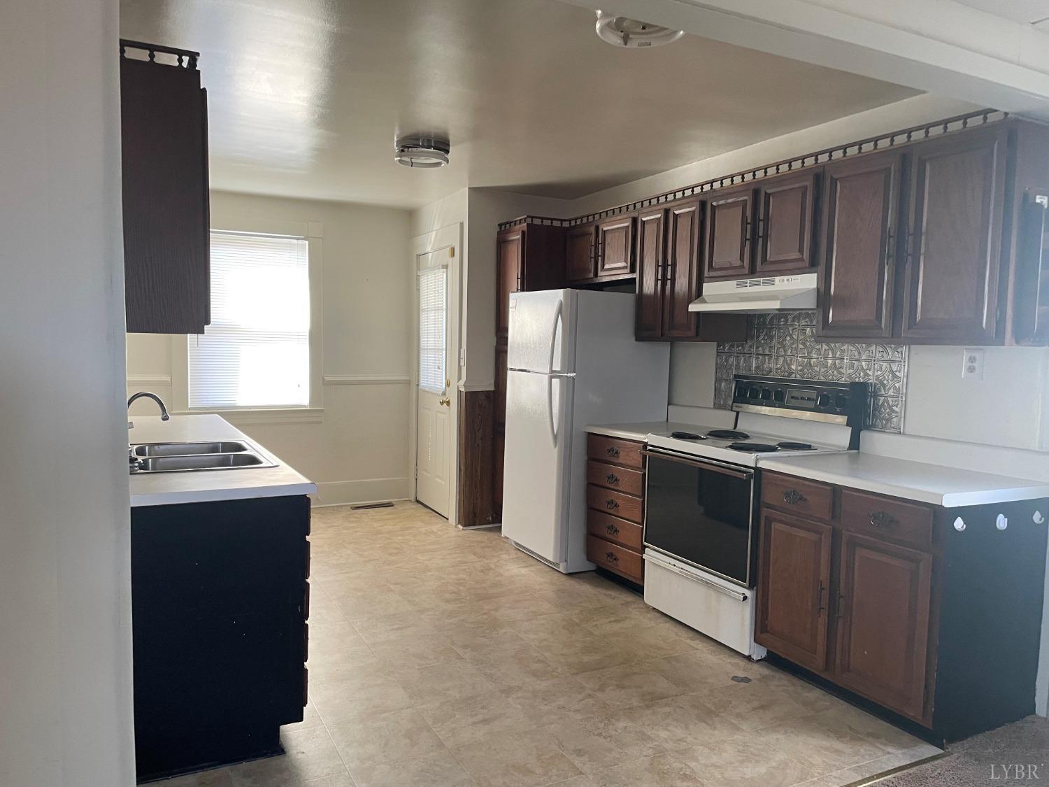 606 Jeter Street Bedford, VA 24523 - Photo 3 of 15 a kitchen with stainless steel appliances granite countertop a refrigerator stove and sink