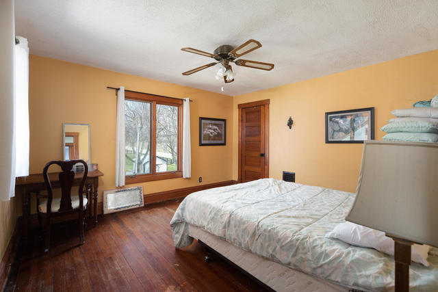 1111 Simons Road Oswego, IL 60543 - Photo 12 of 37 a bedroom with a bed and wooden floor