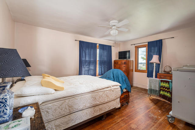 1111 Simons Road Oswego, IL 60543 - Photo 15 of 37 a bedroom with a bed and wooden floor