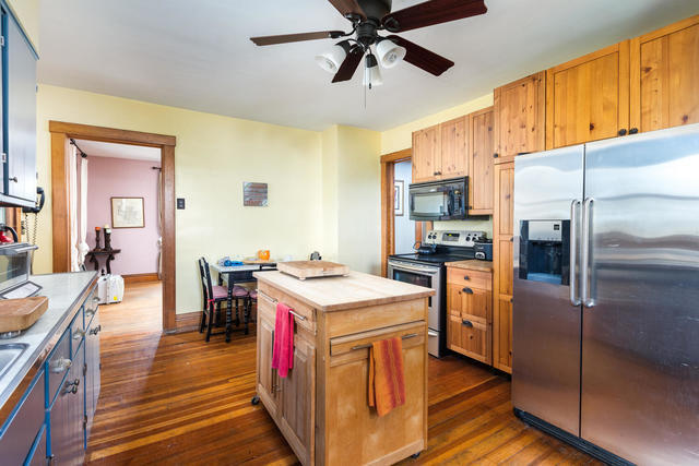 1111 Simons Road Oswego, IL 60543 - Photo 10 of 37 a kitchen with stainless steel appliances granite countertop a refrigerator a stove top oven a sink dishwasher and white cabinets with wooden floor