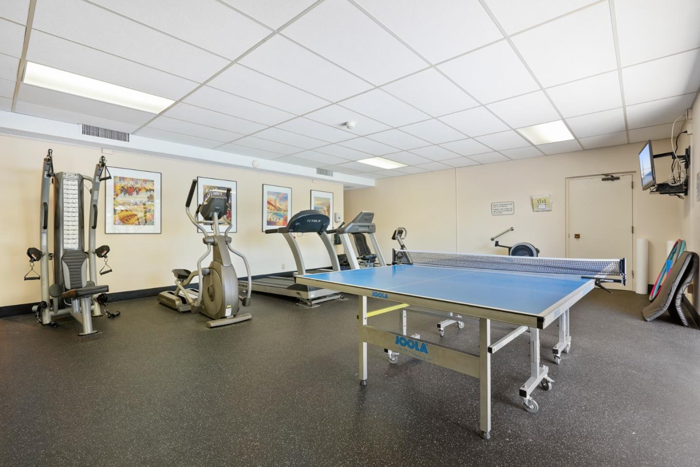 50 Mounds Road, Unit 205 San Mateo, CA 94402 - Photo 21 of 28 a room with gym equipment and a table