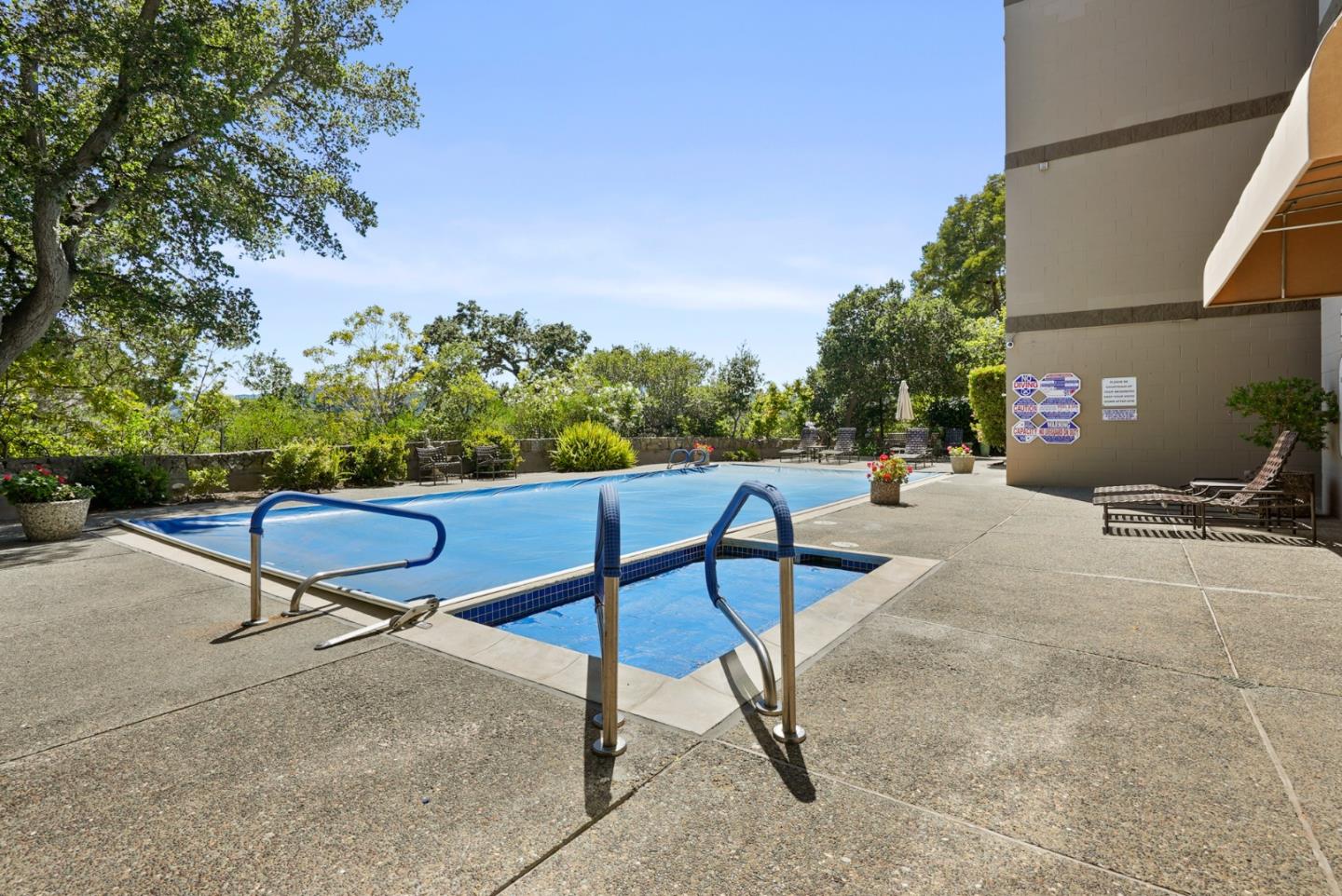 50 Mounds Road, Unit 205 San Mateo, CA 94402 - Photo 23 of 28 a swimming pool with outdoor seating and trees