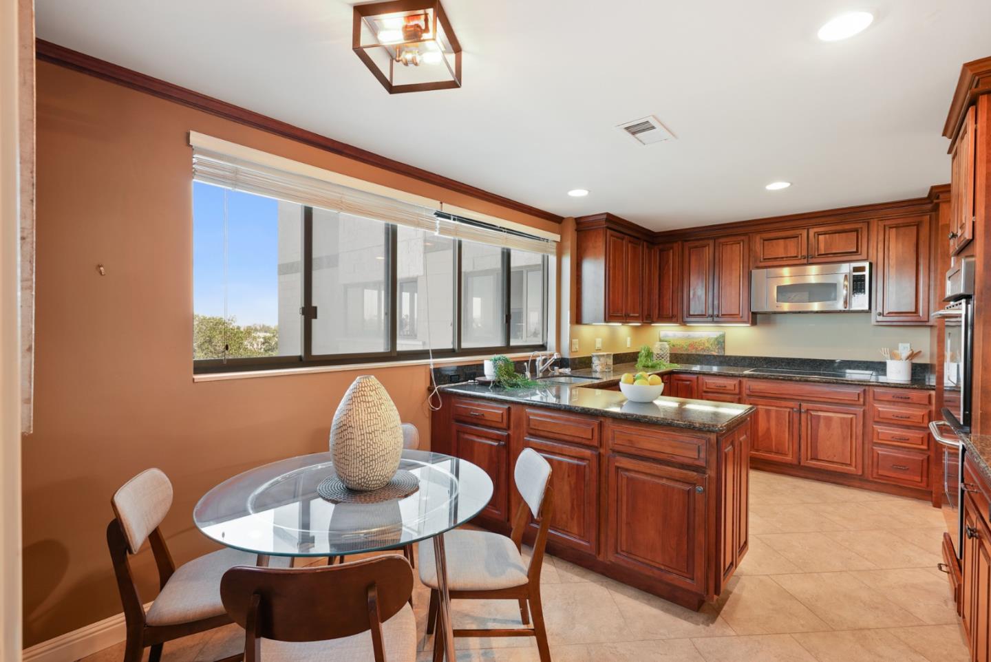 50 Mounds Road, Unit 205 San Mateo, CA 94402 - Photo 9 of 28 a kitchen with stainless steel appliances granite countertop a stove a sink a dining table and chairs