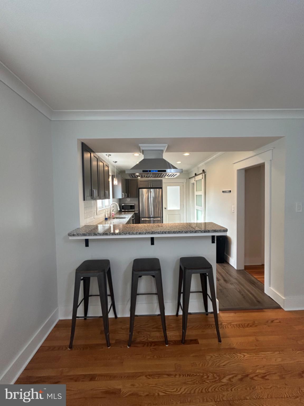Modern kitchen with sleek bar seating.