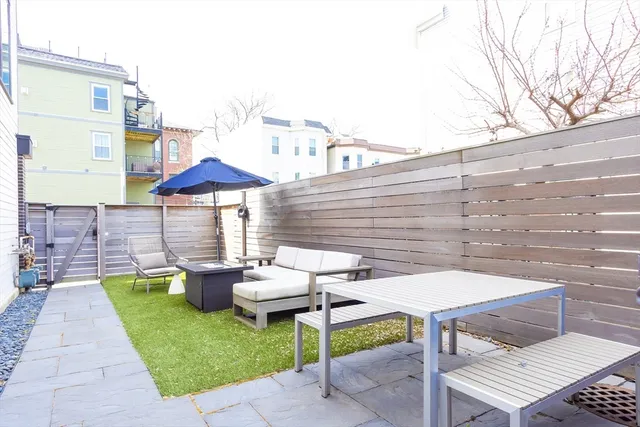 a view of a patio with chairs and a table