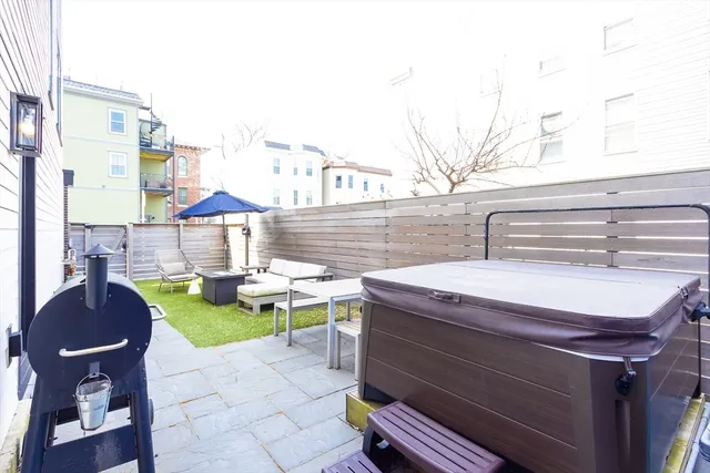 a view of a patio with table and chairs and potted plants