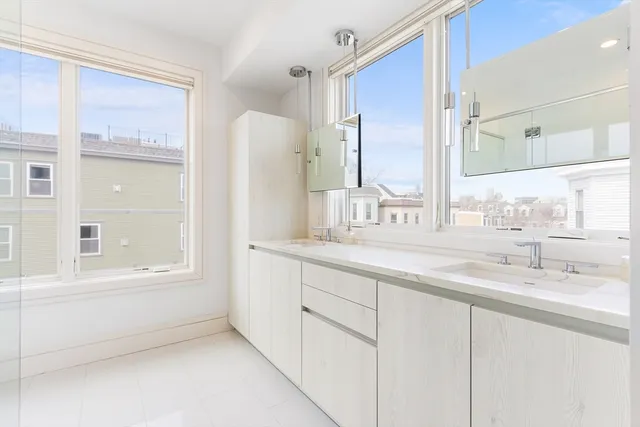 a bathroom with a double vanity sink and a mirror