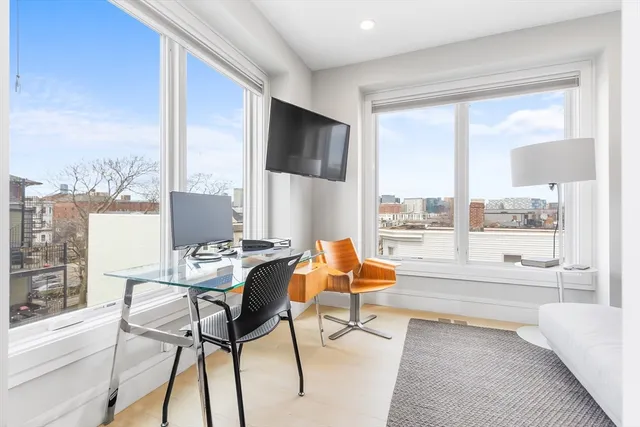 a living room with furniture and a floor to ceiling window