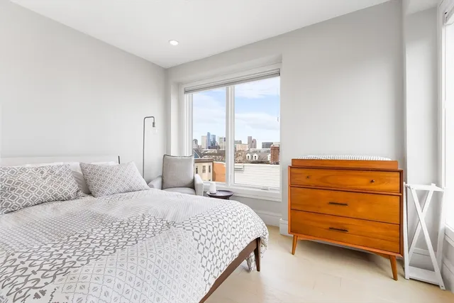 a bedroom with a bed and a dresser