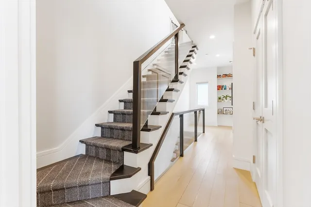 a view of entryway and hall with wooden floor