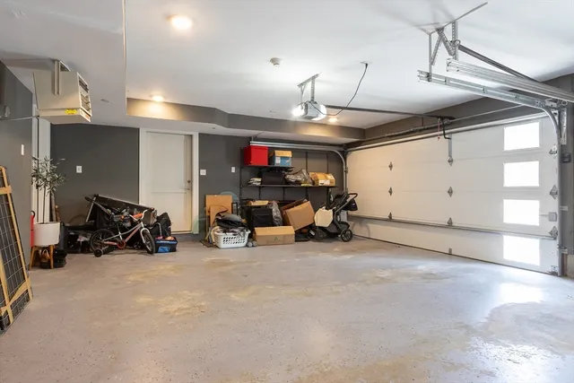 a view of a garage with a bike and white car