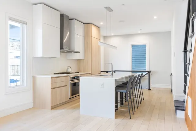 a kitchen with a stove a sink and a refrigerator