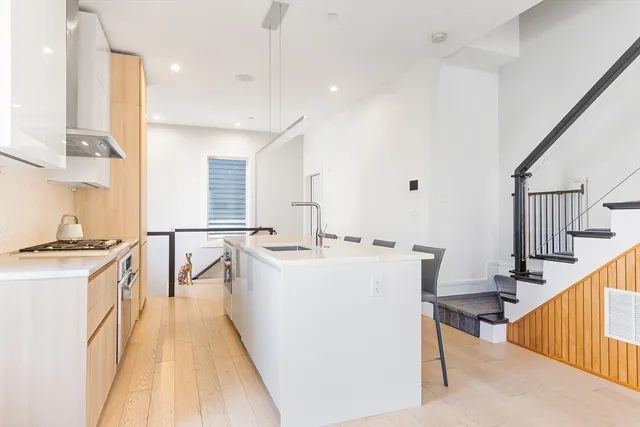 a kitchen with sink a stove and refrigerator
