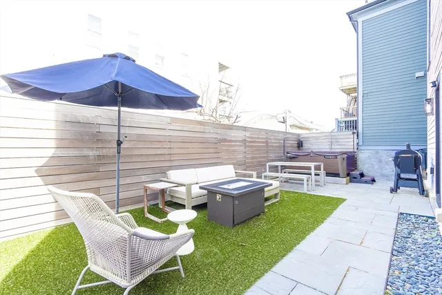 a view of a backyard with sitting area