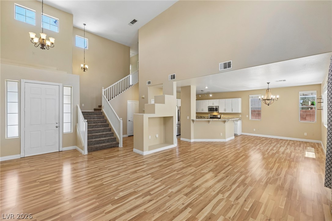 1727 Millstream Way Henderson, NV 89074 - Photo 46 of 46 A grand entrance with high ceilings and a flowing open floorplan leads to the modern kitchen.