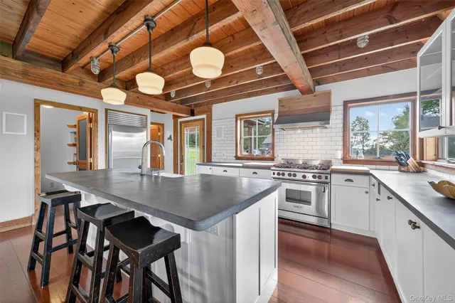 a kitchen with cabinets table and chairs