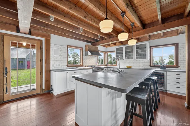 a kitchen with a table chairs and wooden floors