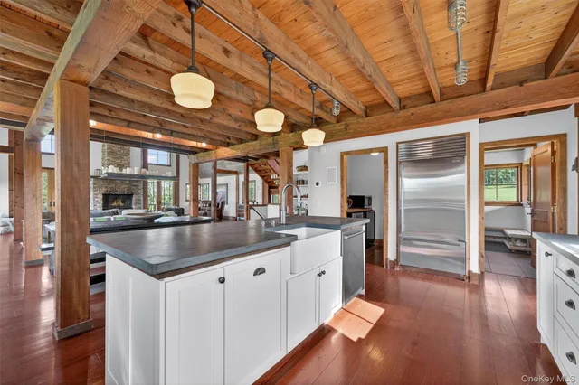 a kitchen with stainless steel appliances granite countertop a sink and a large window