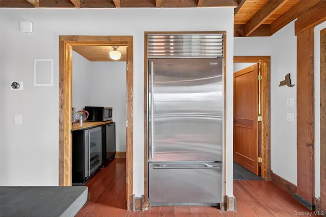 a room with wooden floor and a fireplace