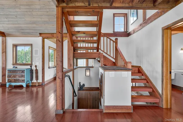 a view of entryway and hall with wooden floor