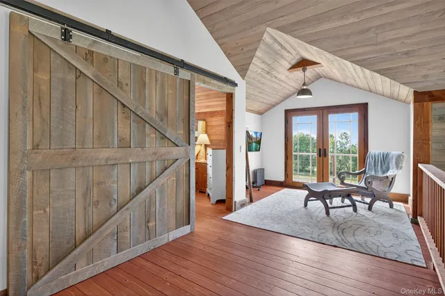 a balcony with furniture and wooden floor
