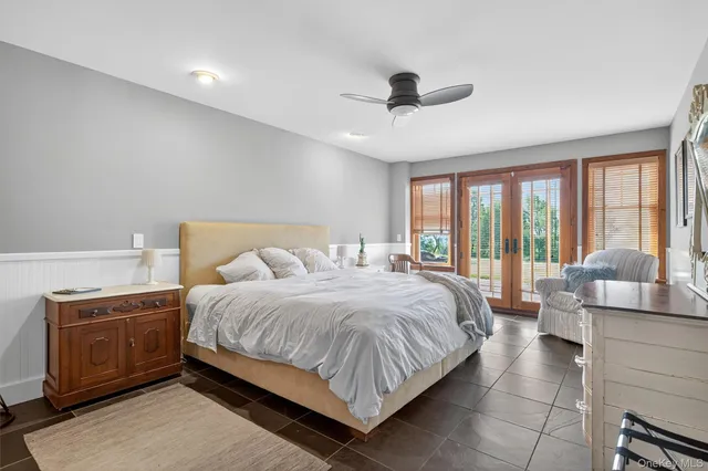 a bedroom with a large bed and a large window