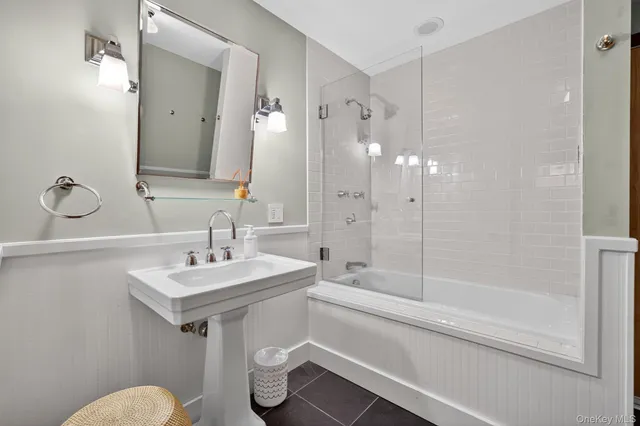 a bathroom with a sink toilet a mirror and shower