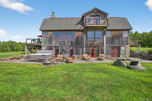a front view of a house with swimming pool having outdoor seating