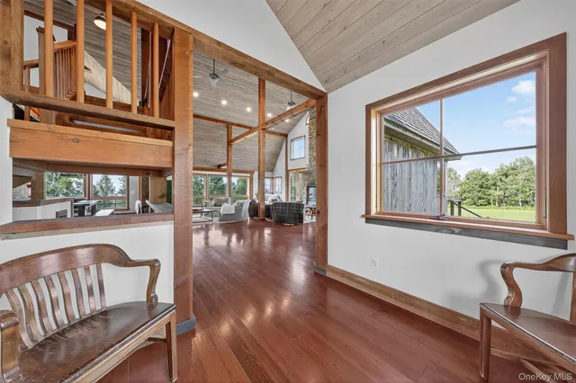 a view of a porch with furniture and wooden floor