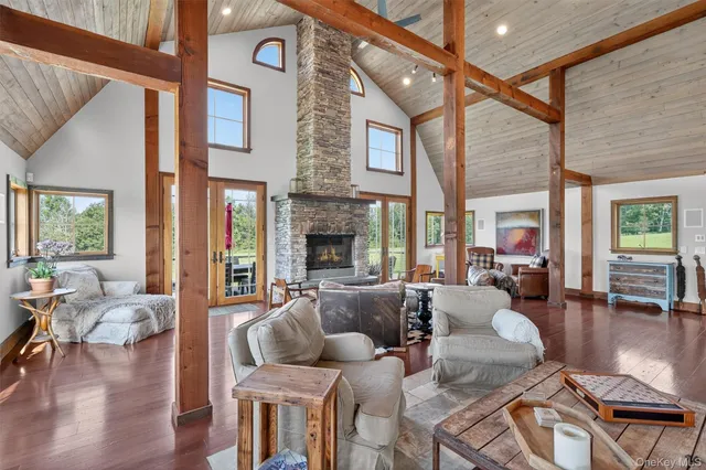 a living room with fireplace furniture and a large window