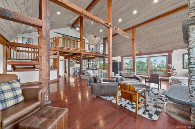 a living room with fireplace furniture and a large window