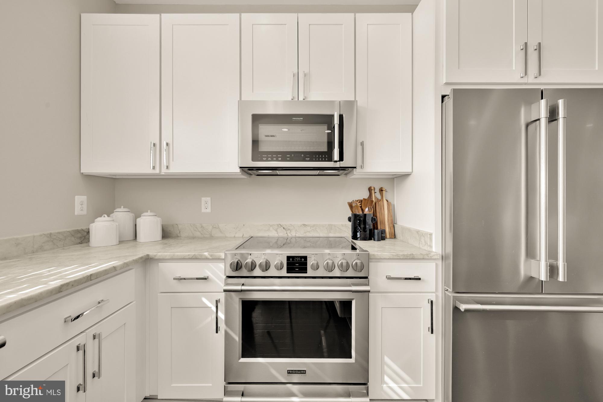 3302 9th Street Northeast, Unit 2 Washington, DC 20017 - Photo 11 of 40 a kitchen with stainless steel appliances white cabinets and a stove