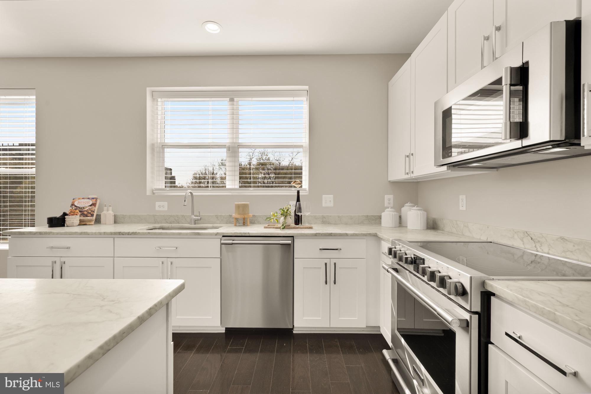 3302 9th Street Northeast, Unit 2 Washington, DC 20017 - Photo 12 of 40 a kitchen with granite countertop white cabinets and white appliances