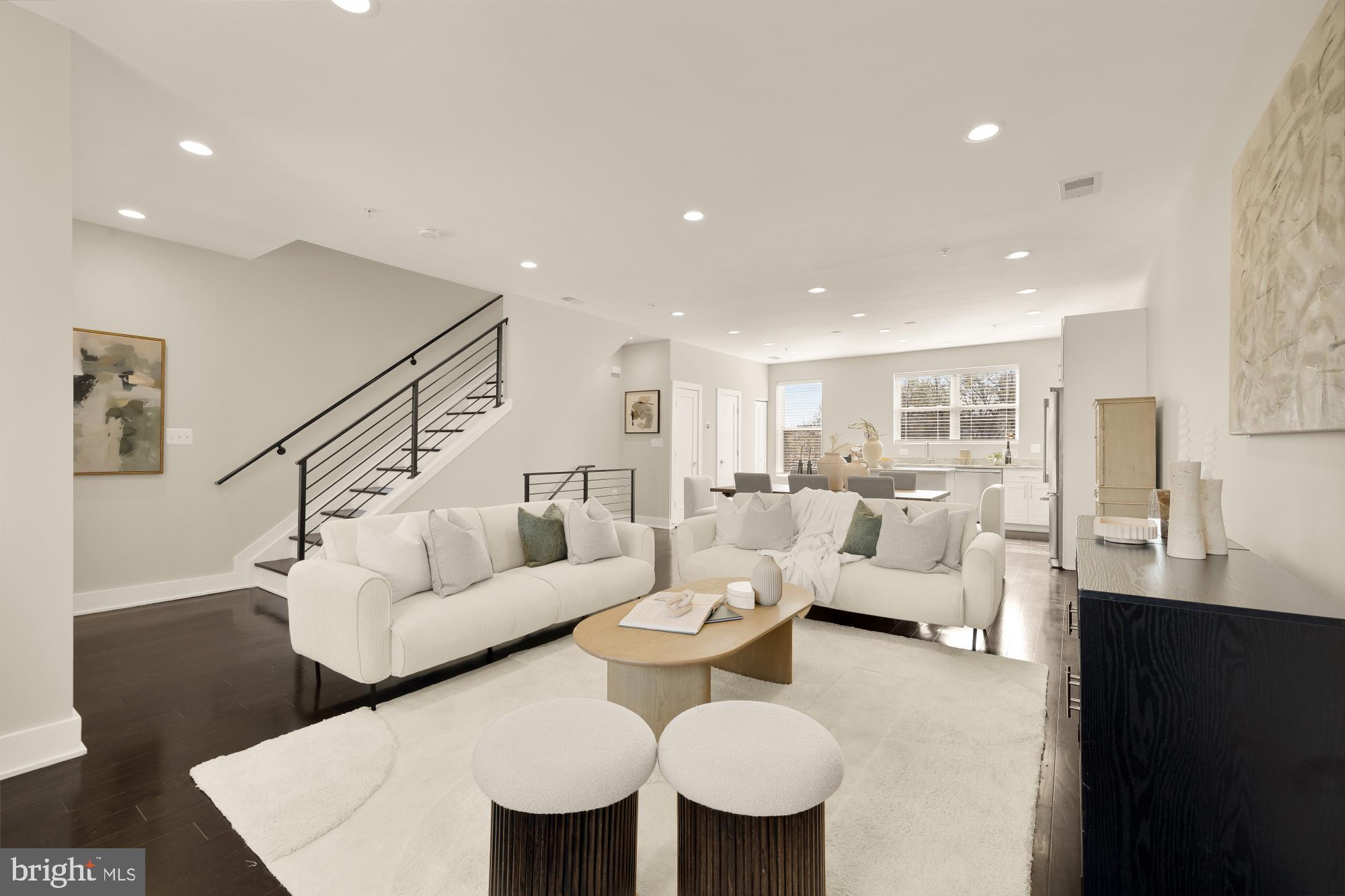 3302 9th Street Northeast, Unit 2 Washington, DC 20017 - Photo 19 of 40 a living room with furniture kitchen view and a wooden floor