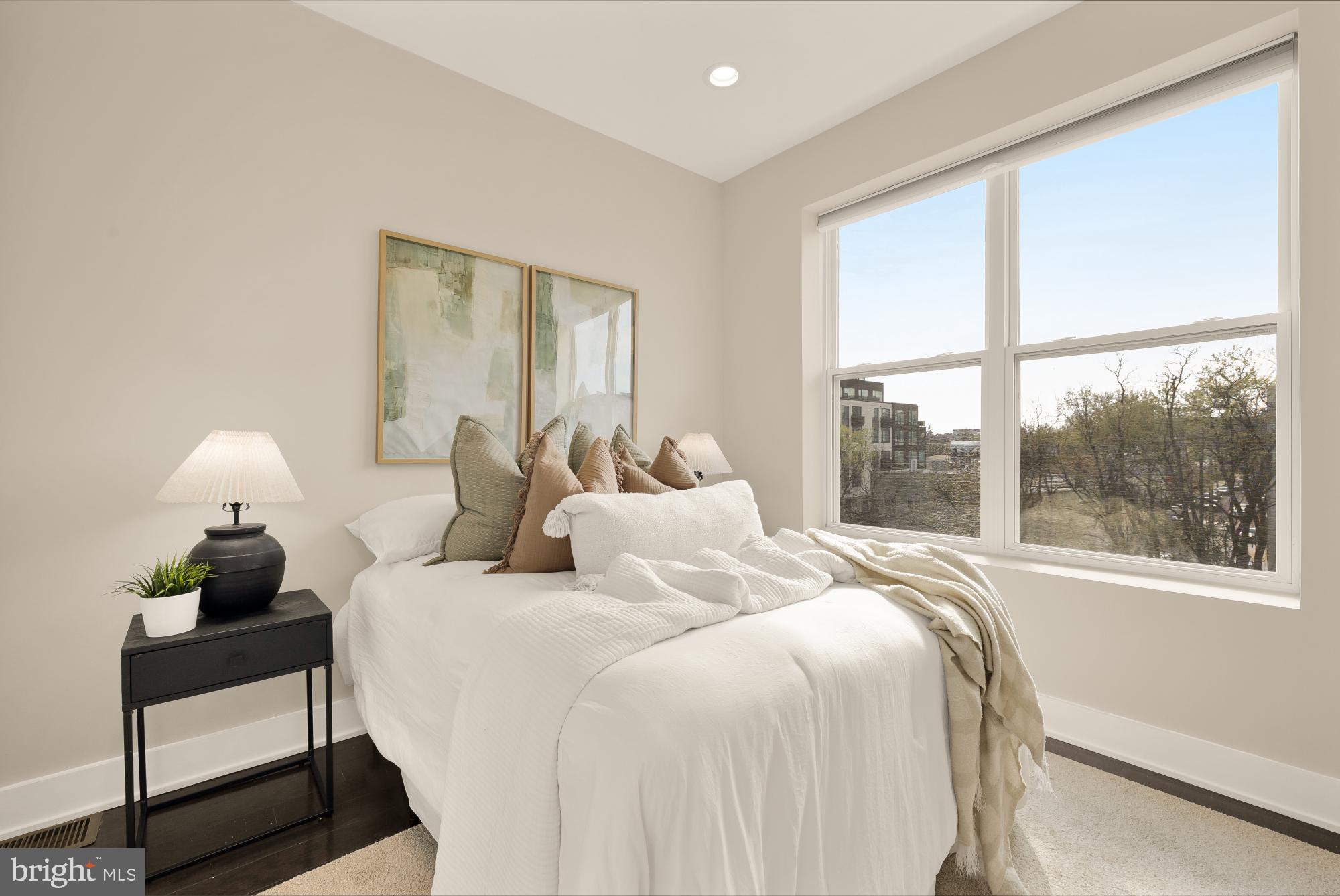 3302 9th Street Northeast, Unit 2 Washington, DC 20017 - Photo 23 of 40 a bedroom with a bed and a large window