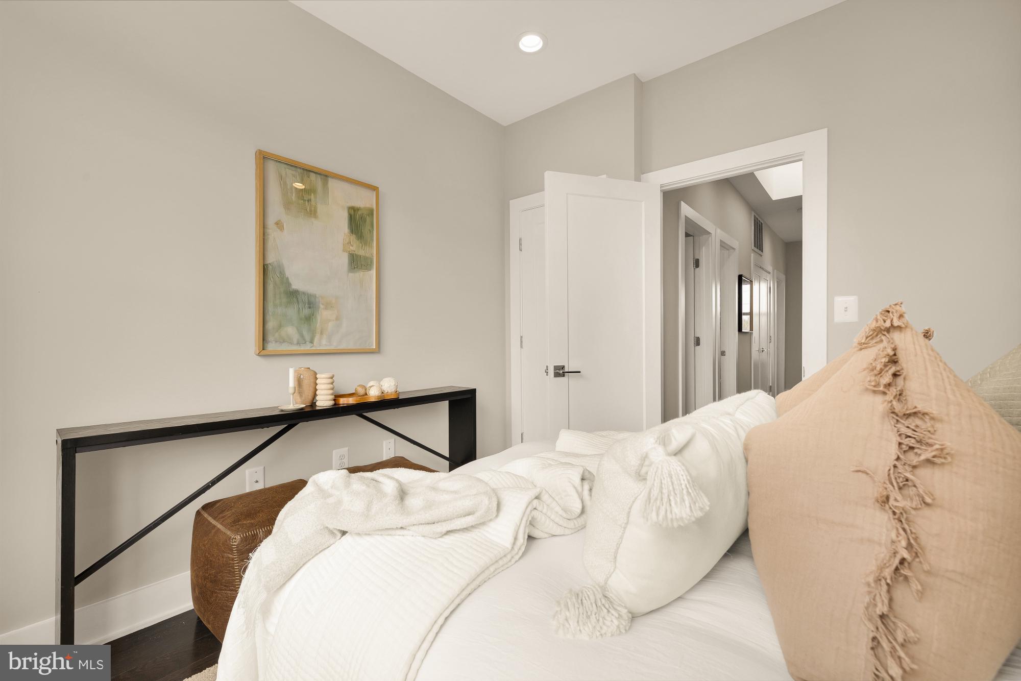 3302 9th Street Northeast, Unit 2 Washington, DC 20017 - Photo 24 of 40 a bedroom with a bed and a painting on the wall