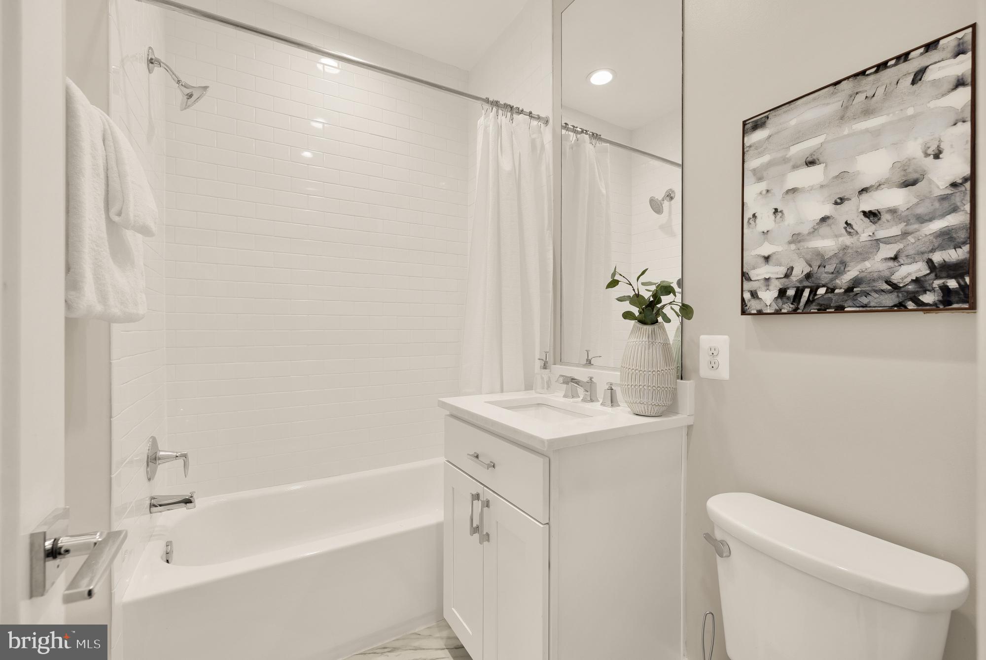 3302 9th Street Northeast, Unit 2 Washington, DC 20017 - Photo 28 of 40 a bathroom with a sink a toilet and shower