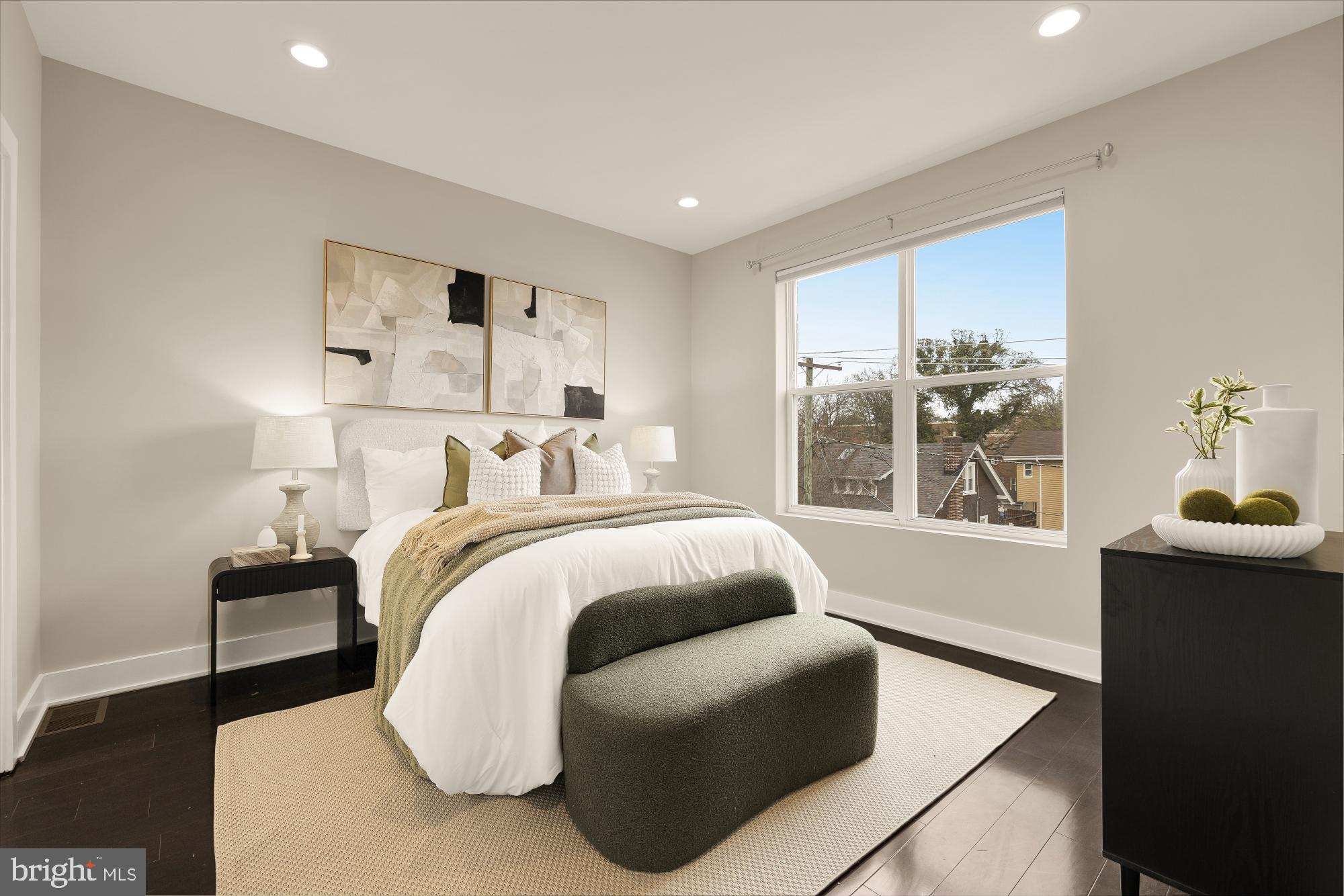 3302 9th Street Northeast, Unit 2 Washington, DC 20017 - Photo 30 of 40 a bedroom with a bed and wooden floor