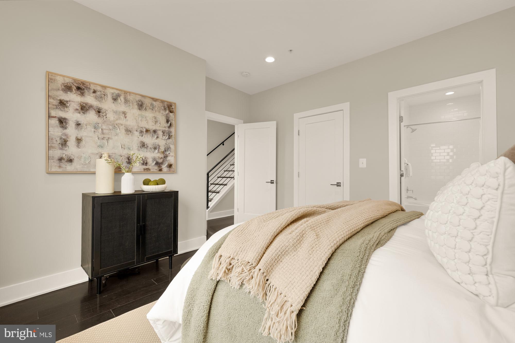 3302 9th Street Northeast, Unit 2 Washington, DC 20017 - Photo 32 of 40 a spacious bedroom with a bed and wooden floor