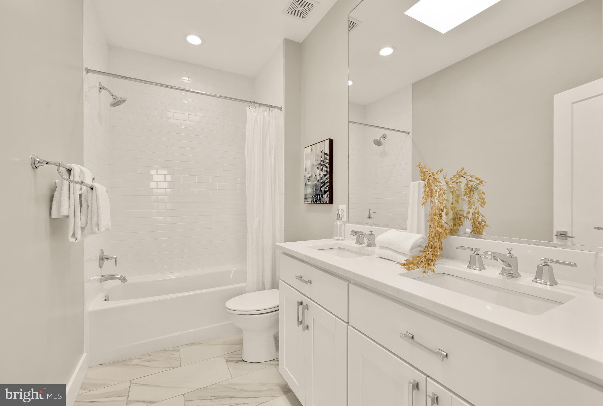 3302 9th Street Northeast, Unit 2 Washington, DC 20017 - Photo 33 of 40 a bathroom with a granite countertop sink a toilet and shower