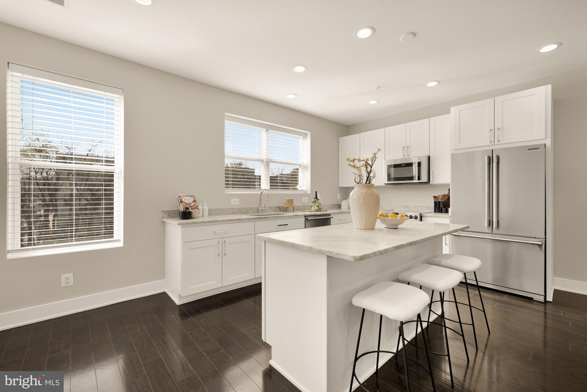 3302 9th Street Northeast, Unit 2 Washington, DC 20017 - Photo 7 of 40 a kitchen with white cabinets and white appliances