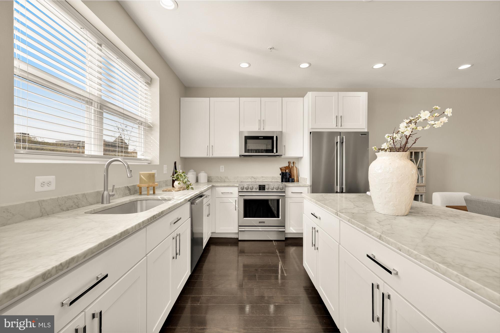 3302 9th Street Northeast, Unit 2 Washington, DC 20017 - Photo 8 of 40 a kitchen with a sink dishwasher a stove a microwave and a refrigerator
