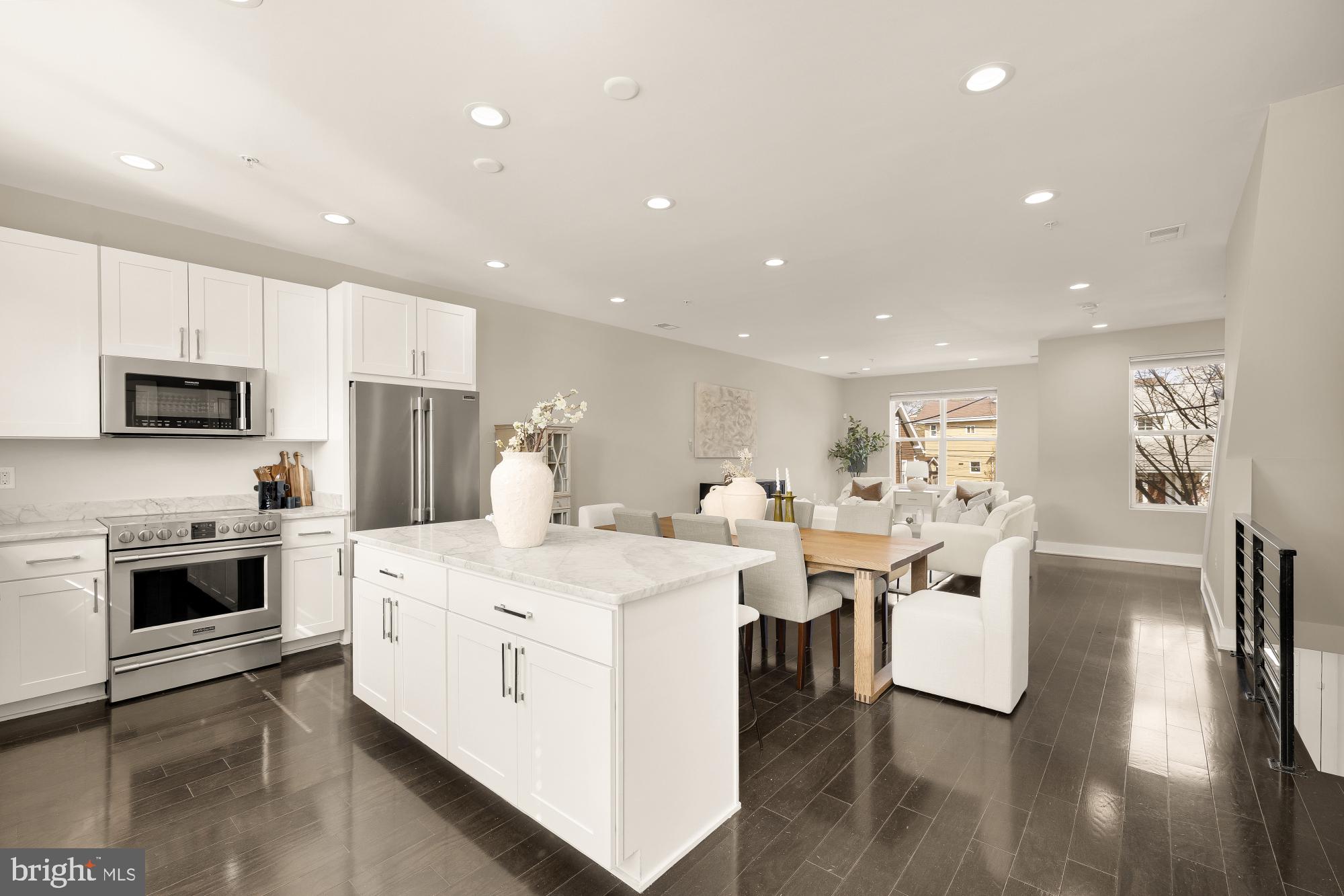 3302 9th Street Northeast, Unit 2 Washington, DC 20017 - Photo 9 of 40 a kitchen with stainless steel appliances kitchen island granite countertop a stove and a sink