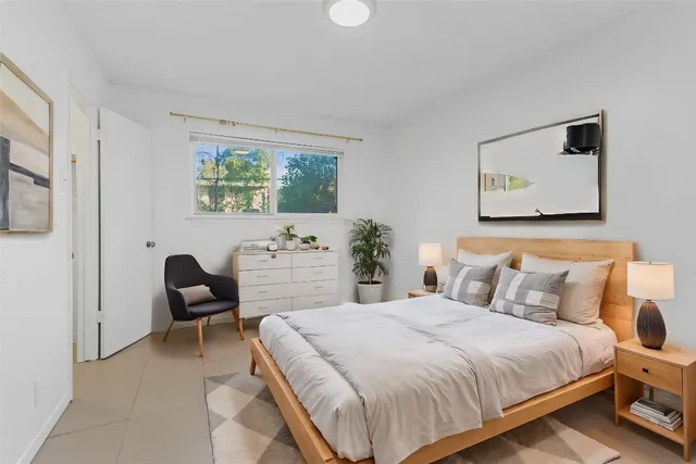 a bedroom with a bed and a chair